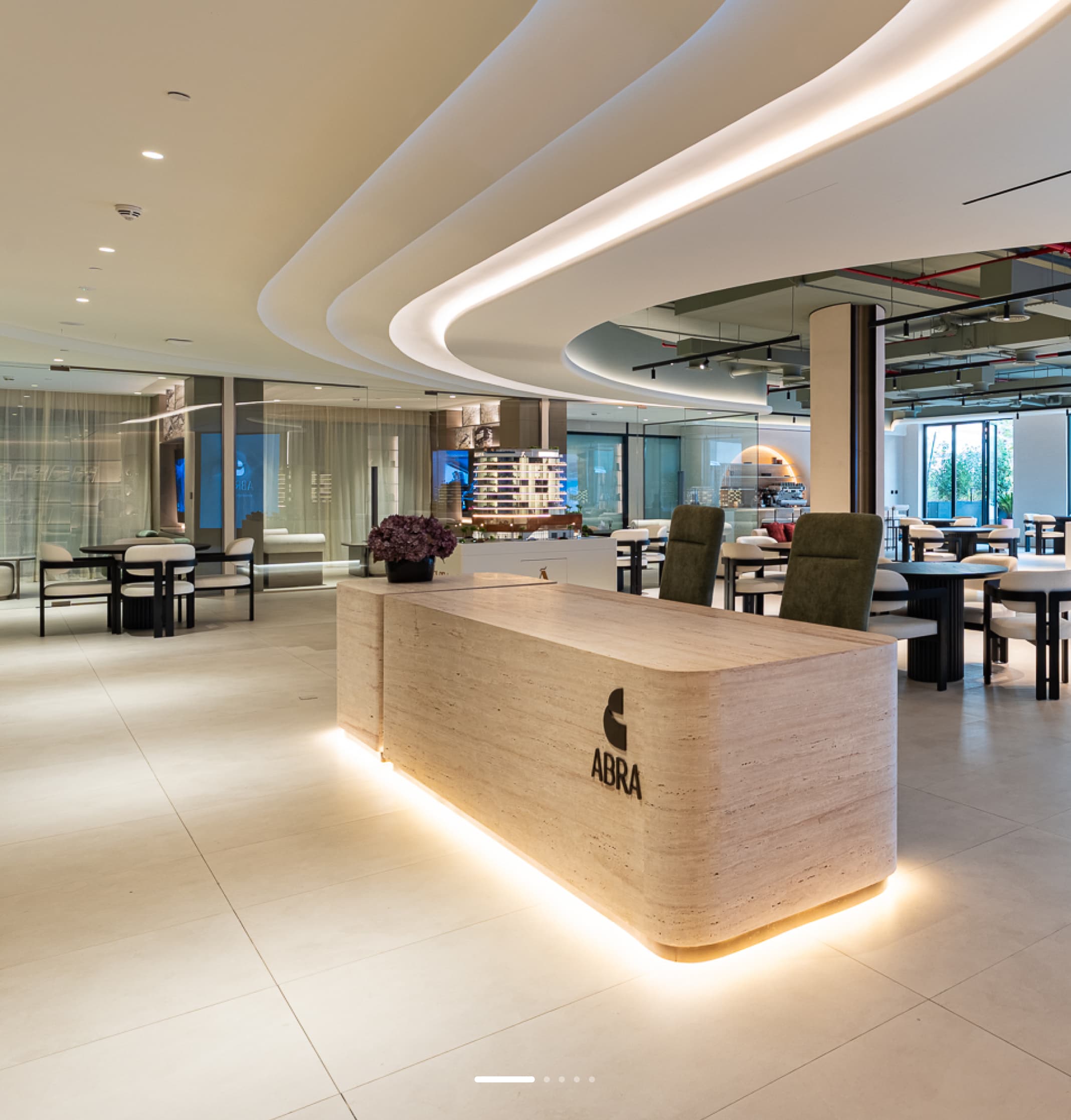 ABRA experience centre reception with a wooden desk and glass meeting rooms