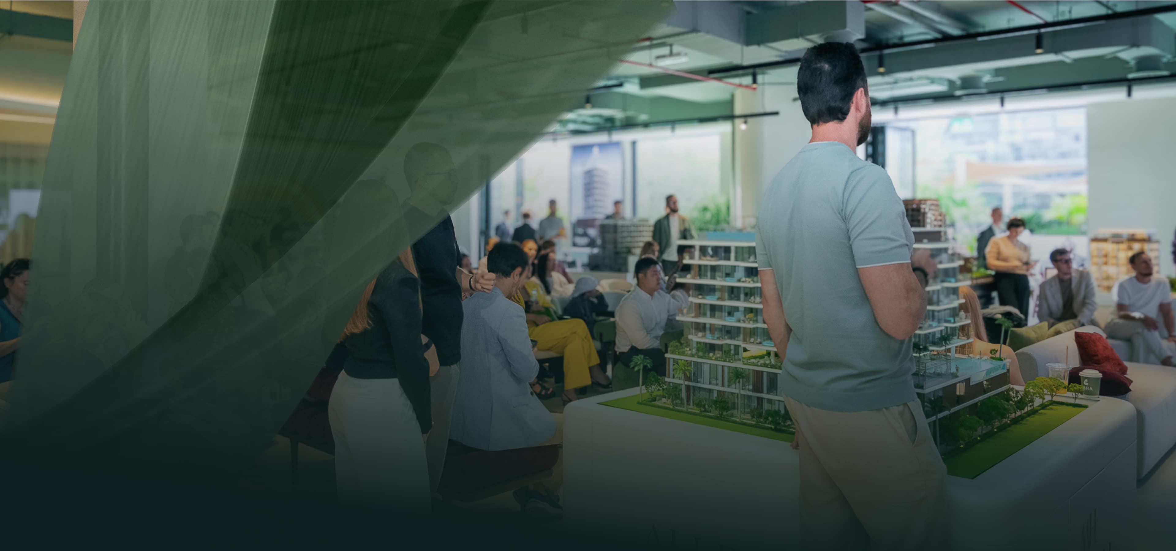 ABRA partners reviewing an architectural model in a showroom