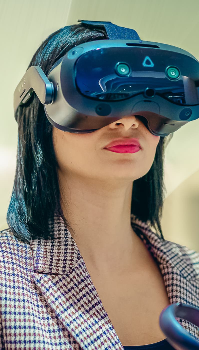Team member using a VR headset in a patterned blazer